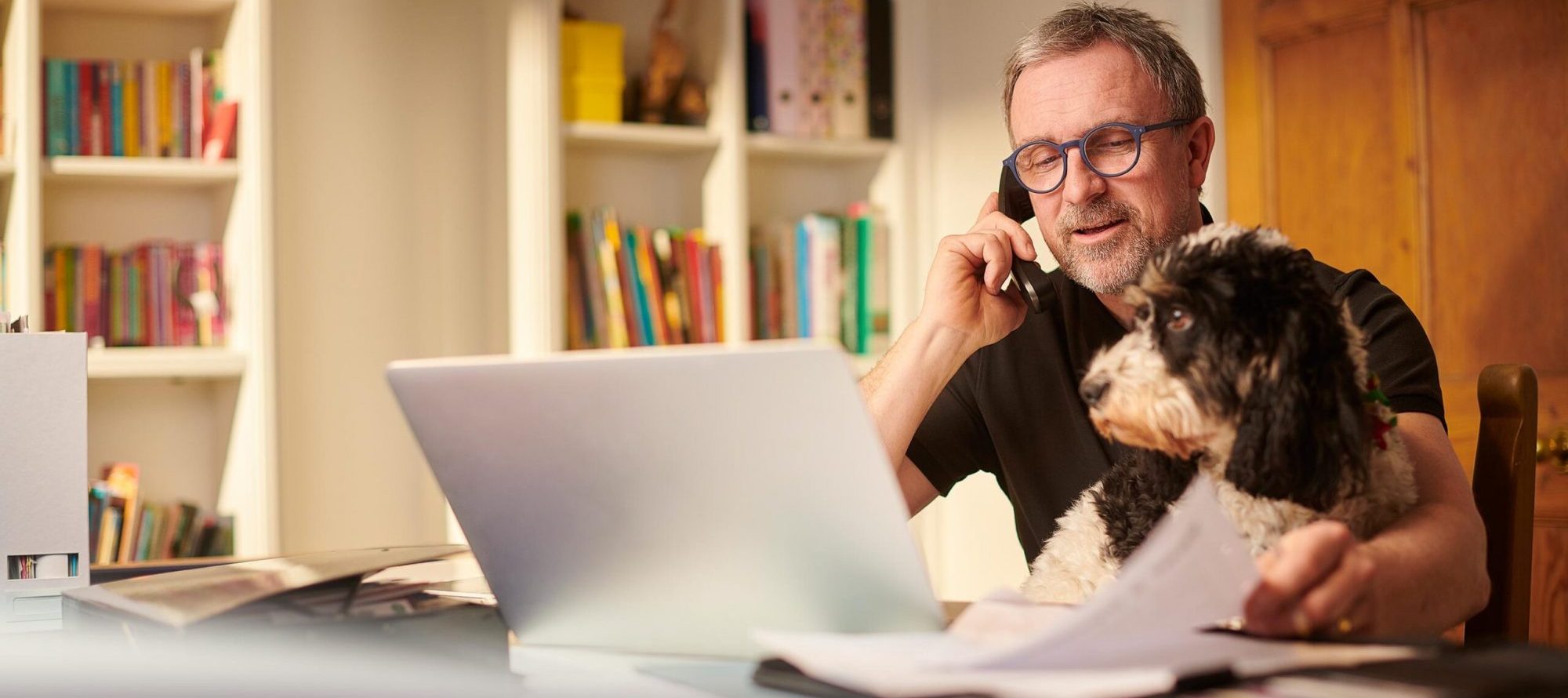 man on phone with dog