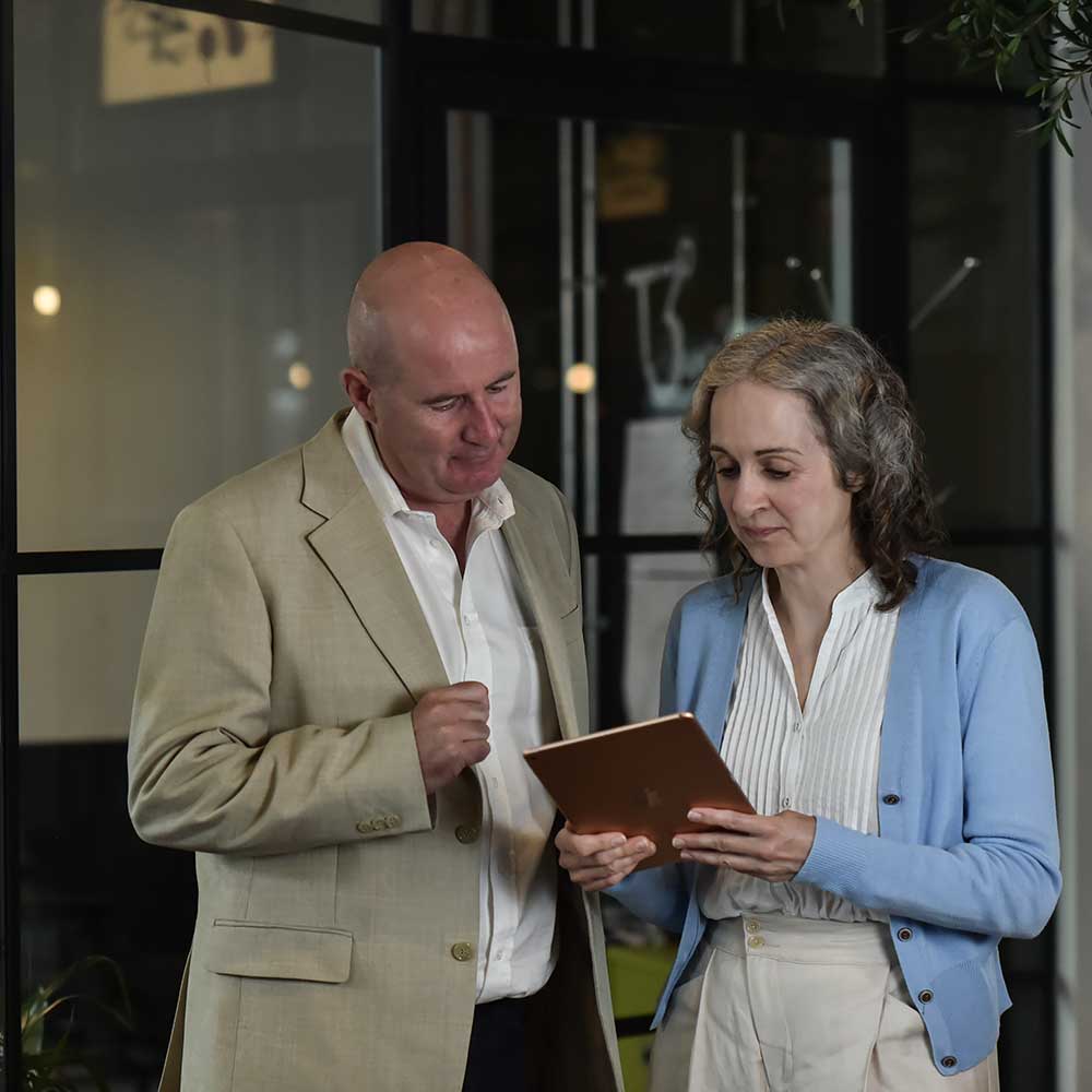 Two attorneys looking at a tablet